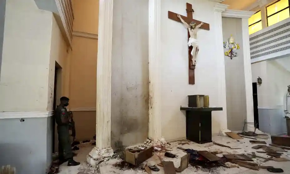 A police officer stands guard inside the Saint Francis Catholic church the day after the attack.